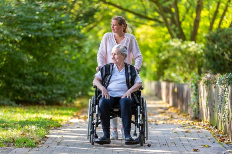 Proveer at Quail Creek | Senior woman out for a stroll with her caregiver in her wheelchair